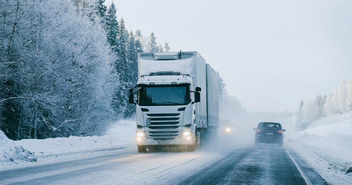 Lastbil och bil på vägen på vintern. (Bild: Shutterstock)